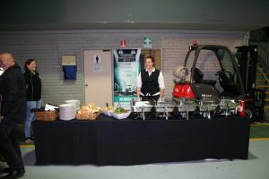 Red Manitou forklift with buffet food infront